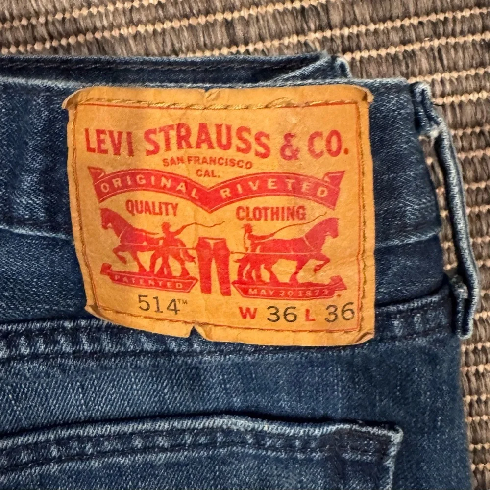 Levi's Men's 514 Straight Jeans in Medium Blue with Distressing